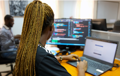 Female AmaliTech developer works on computer