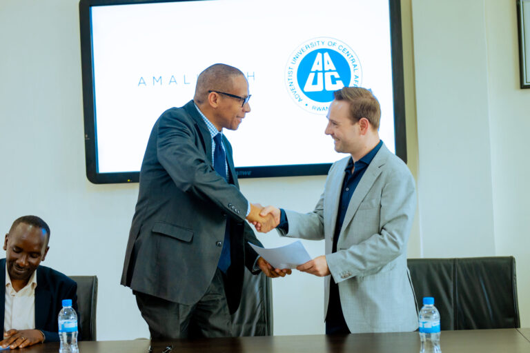 A warm handshake between Christian, AmaliTech's COO, and a representative of AUCA.