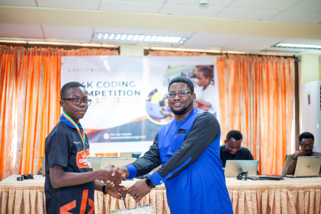 A young boy joyfully receiving a package during a C4K event.